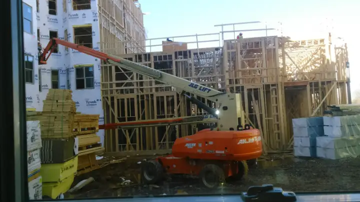 Commercial building renovation with lift equipment on site