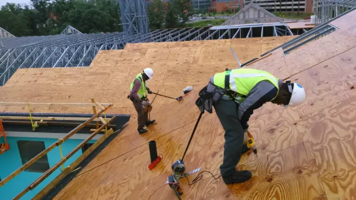Commercial construction crew installing roof sheathing in Maryland