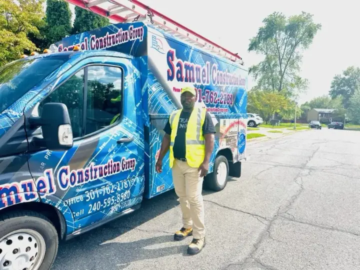 Samuel Construction Group owner standing next to the company work van